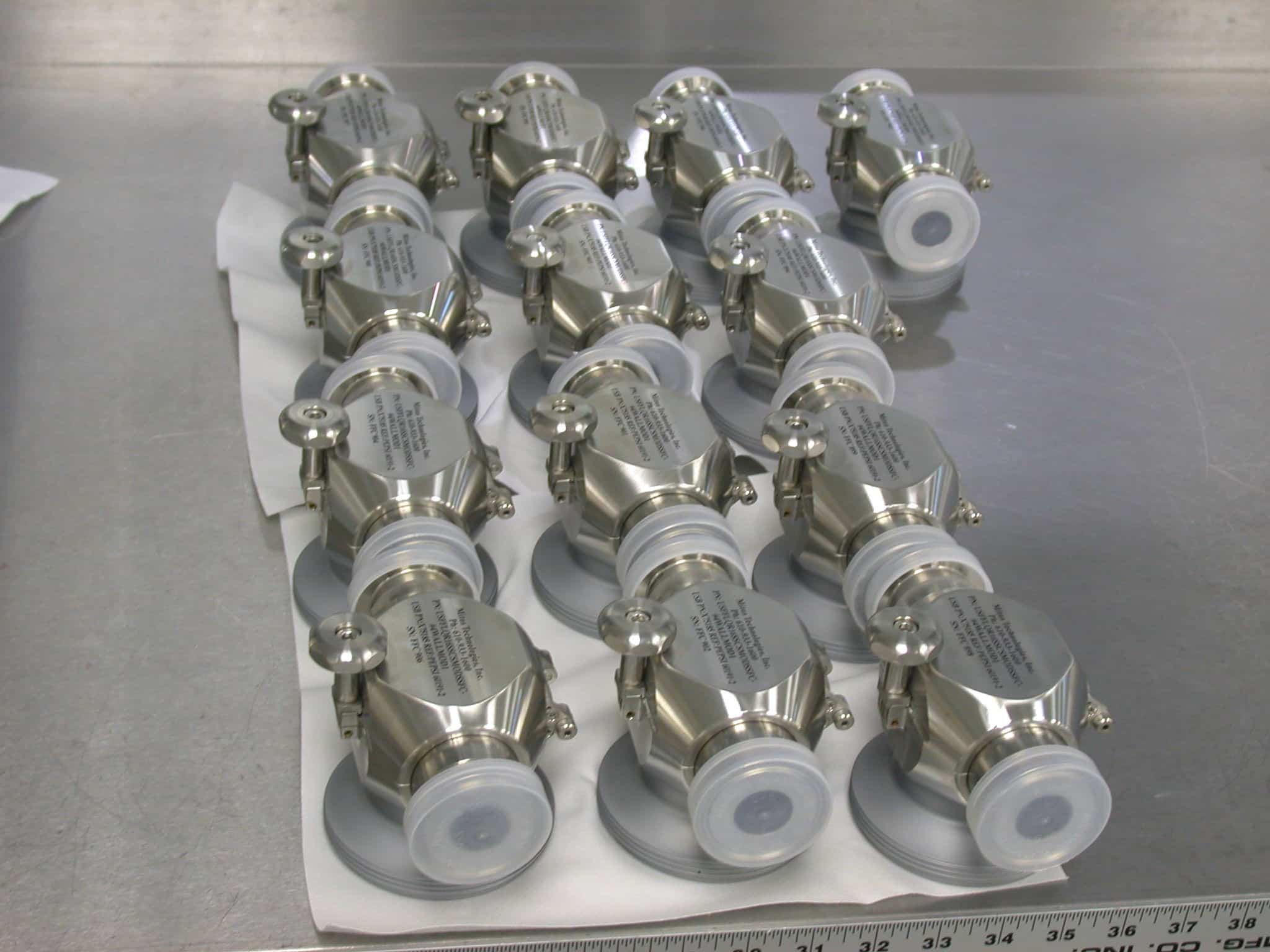 A tray of stainless steel bioprocessing components made by Mitos