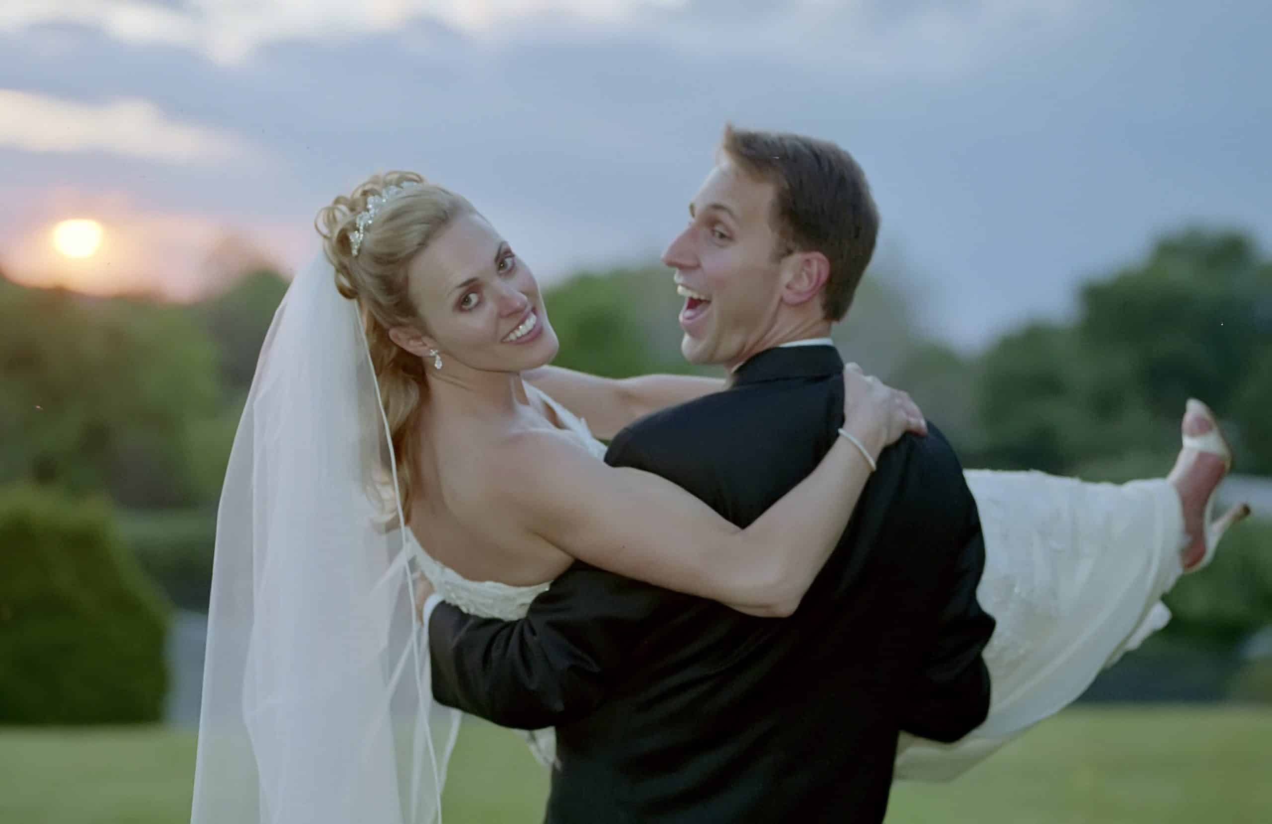 Steve carrying Nicole on their wedding day