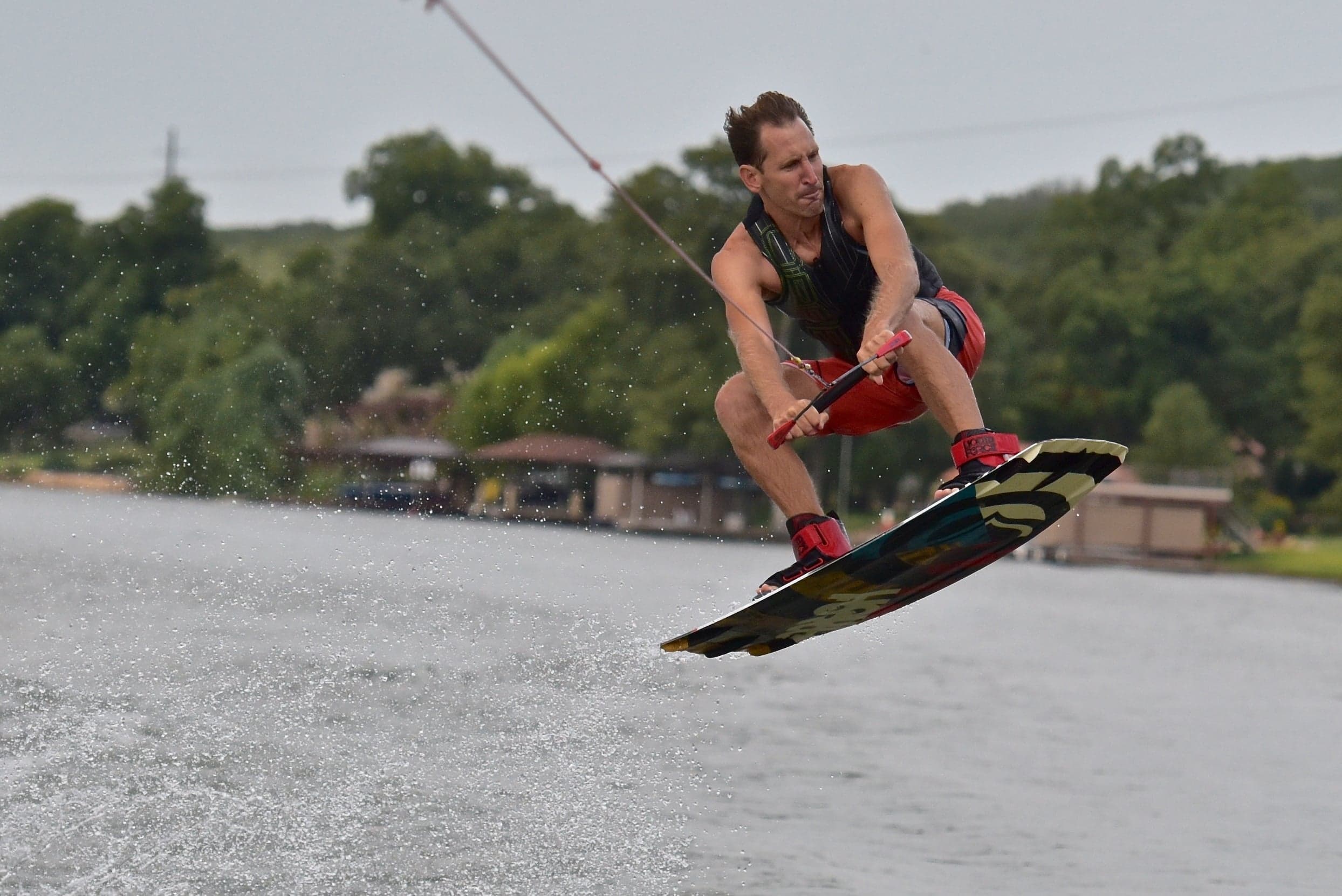 Steve wakeboarding, mid-air off the water
