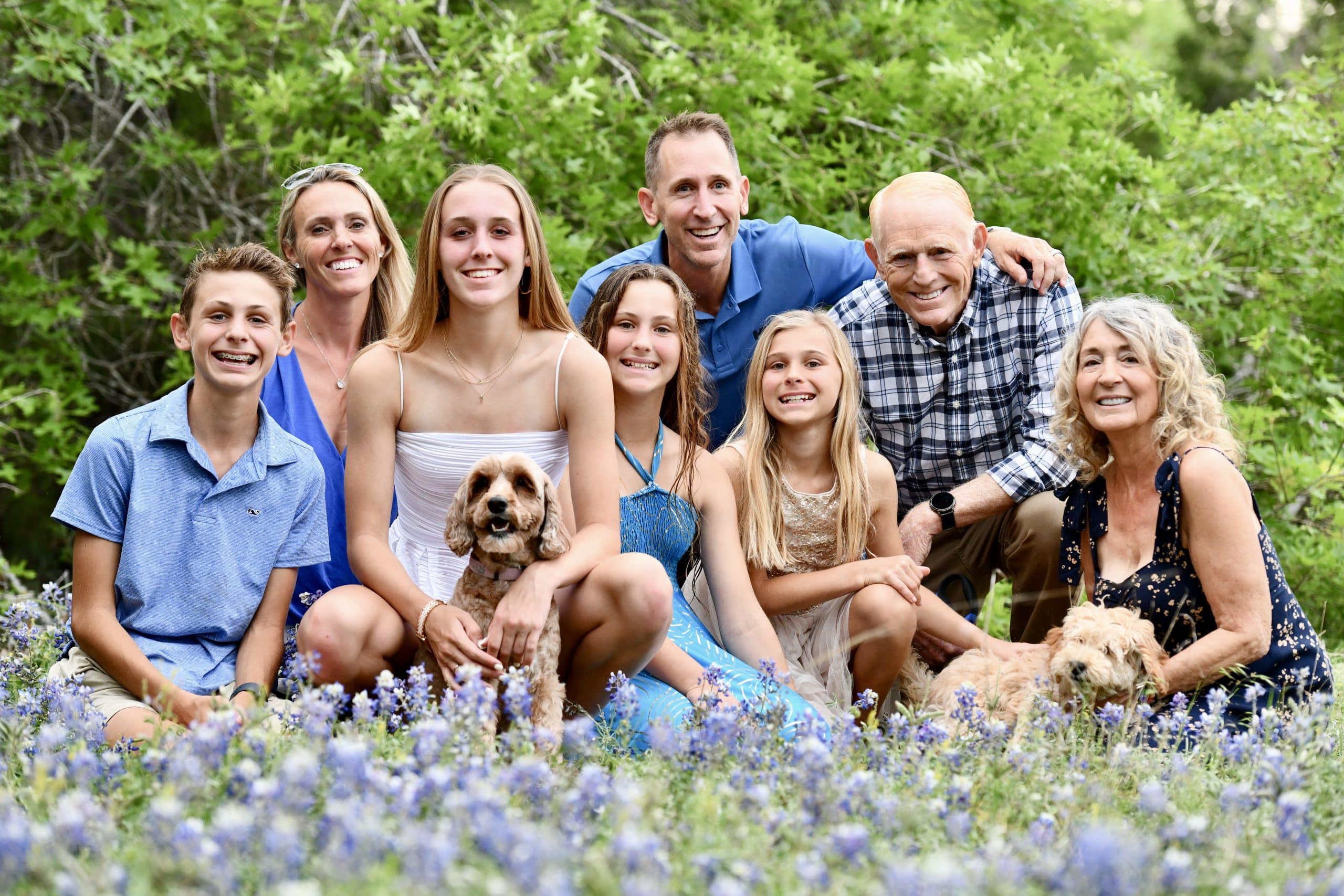 Steve, Nicole and their four children in a field of bluebonnets